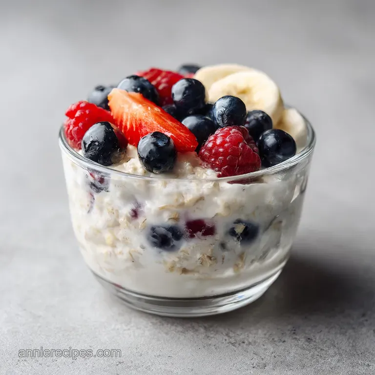 A rustic jar filled with thick, layered oats, topped with a swirl of yogurt and a cascade of colorful fruit.