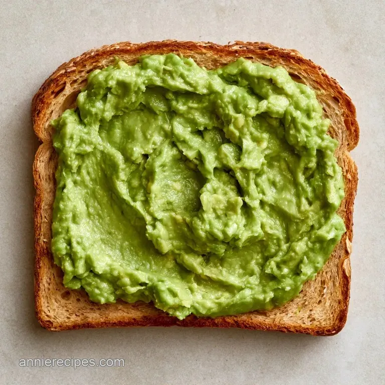 Sourdough toast with mashed green avocado, thin radish slices, and fresh microgreens on a minimalist white plate.