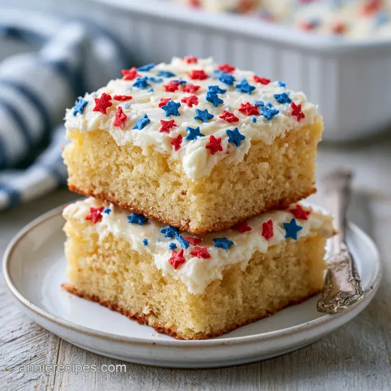 Neatly stacked dessert squares with vibrant tri-color icing on a white ceramic platter with a linen napkin.